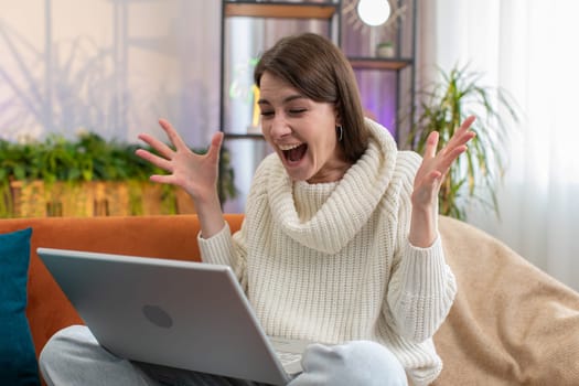 Oh my God Wow. Surprised young woman using laptop computer, receive good news message, shocked by sudden victory celebrate lottery jackpot win purchases online shopping at home. Lifestyle technologies