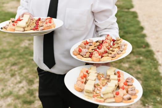 A waiter serves the small appetizers at the wedding