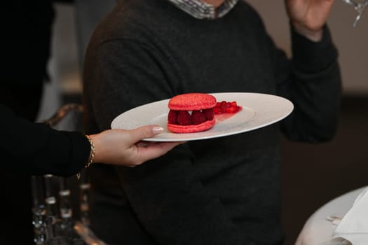 Pink macaroons on a plate at a wedding