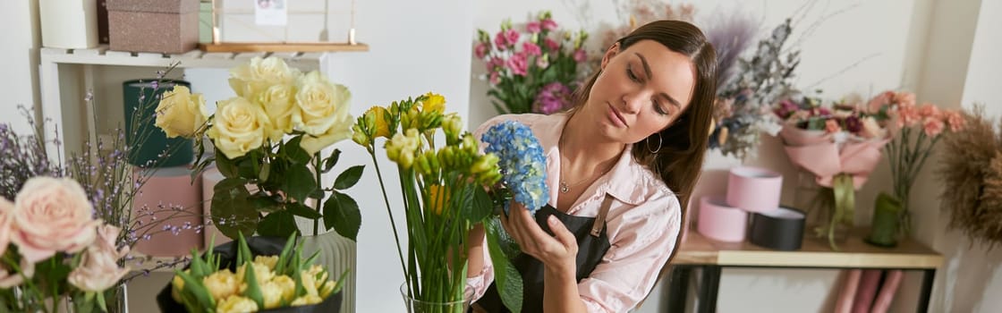 happy professional woman is working in flower shop