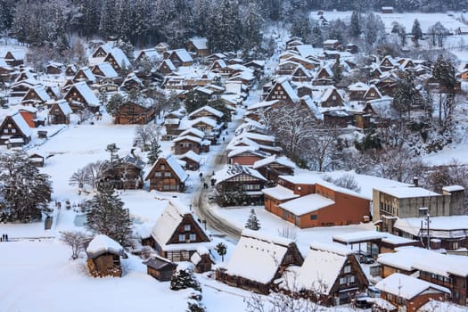 Snow covered A-frame roofs in Shirakawa-go on winter day. High quality photo
