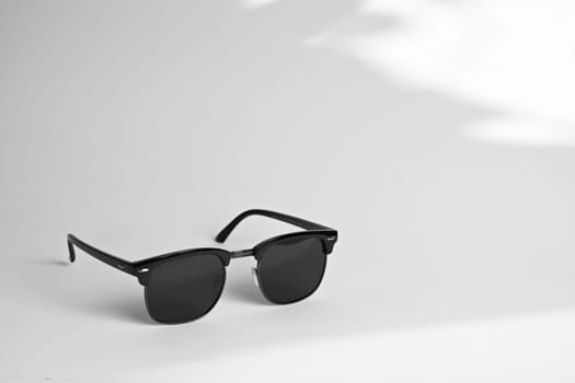 Black glasses on a white background. Side view. Place for text.