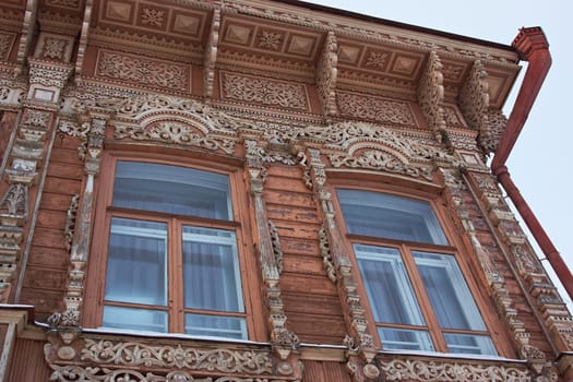 an old building with two windows, an old building with beautiful carved ornaments