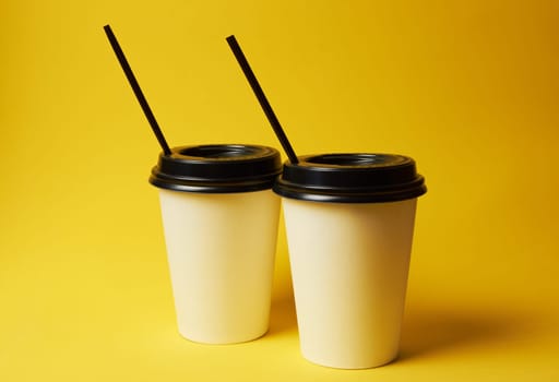 Paper Coffee Container with Black Lid on Yellow Background White Coffee Paper Cup with Black Lid on Yellow Background Takeaway Coffee