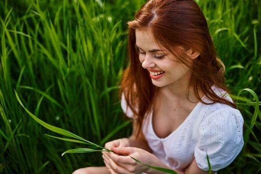 happy woman on vacation sitting in tall grass. High quality photo