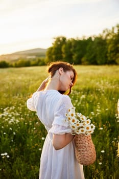 close portrait of a woman turned away from the camera in a light dress and a wicker basket in her hands with chamomile flowers in nature. High quality photo