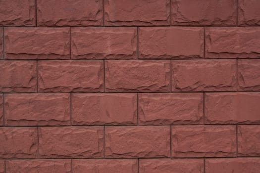 Old brown stone wall Close-up Background of stone tiles with detailed natural texture.