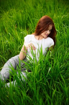 beautiful woman in casual clothes spends weekend in nature. High quality photo