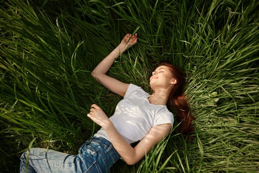 woman resting from worries lying in tall grass. High quality photo