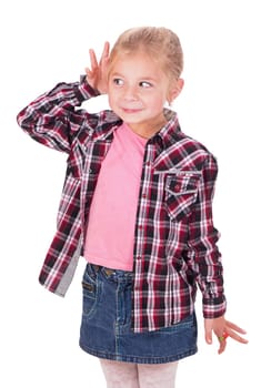 Studio shot portrait of thoughtful little girl who is eavesdropping. Copy space on gray background.