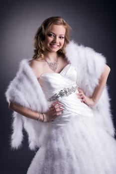 Portrait of beautiful smiling bride posing in studio