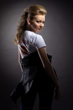 Playful young girl posing in studio on gray background