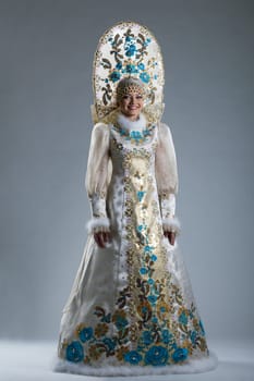 Smiling young girl posing in Russian traditional costume