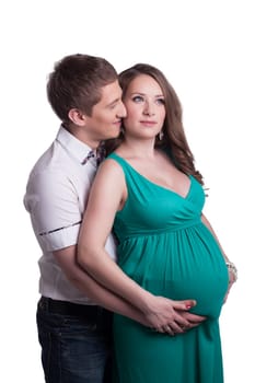 Beautiful pregnant woman with man posing in studio, isolated on white