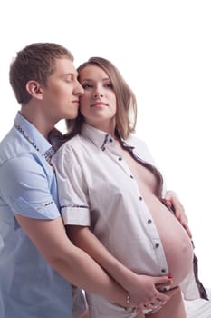 Young man hugging pretty pregnant woman, on white background