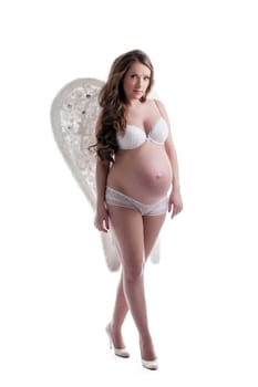 Charming pregnant woman posing in lingerie isolated on white