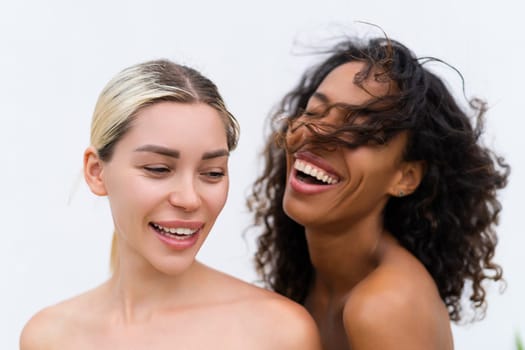 Woman close beauty portrait mixed race black skin and white skin, two female on white background