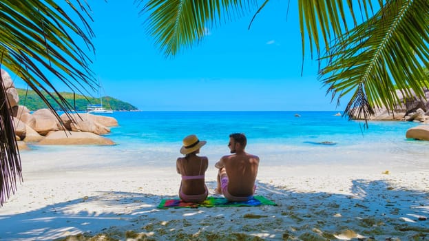 Anse Lazio Praslin Seychelles, a young couple of men and women on a tropical beach during a luxury vacation in Seychelles
