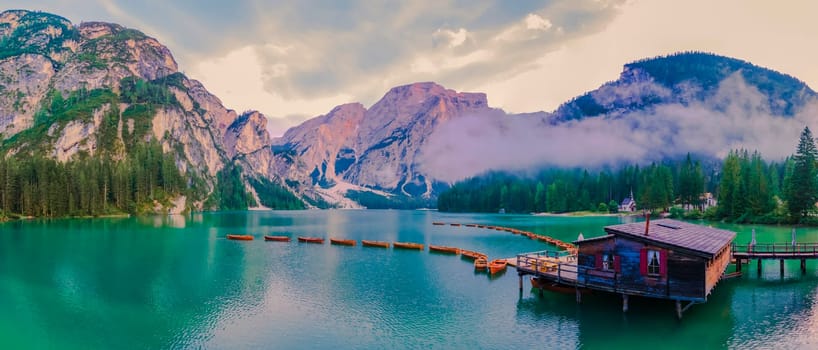 Lake Braies also known as Pragser Wildsee or Lago di Braies in Dolomites Mountains, Sudtirol, Italy. Romantic place with typical wooden boats on the alpine lake. Hiking travel and adventure