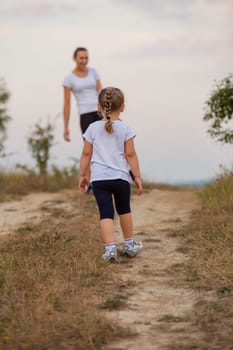 mother and daughter walking outdoors