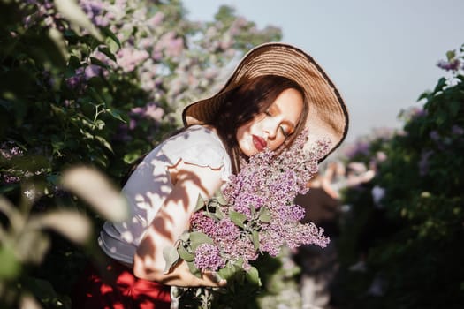 A fashionable girl with dark hair, a spring portrait in lilac tones in summer. Bright professional makeup