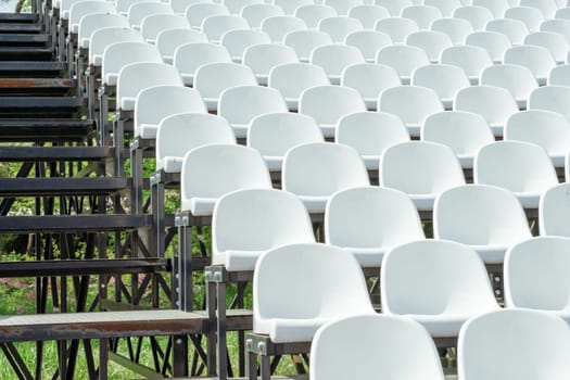 Seats of tribune on sport stadium. Concept of fans, chairs for audience, cultural environment concept. mpty seats, modern stadium