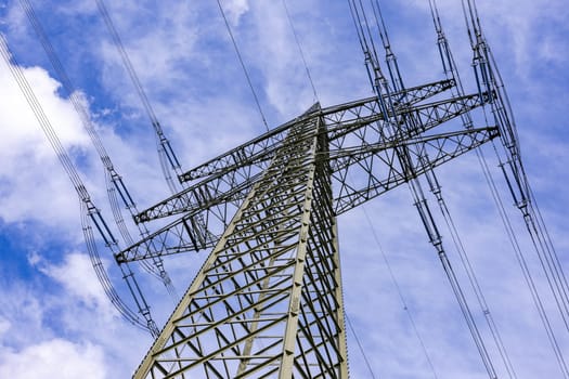 Power pole construction made of steel with many wires to transport electricity over land, Germany