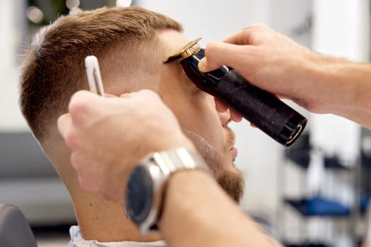 Barber shaving bearded man with retro knife in barber shop. close-up