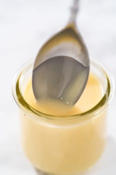 White chocolate ganache in a small glass mason jar.