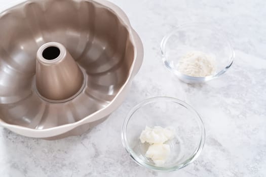 Greasing bundt cake pan to bake July 4th bundt cake with chocolate stars.