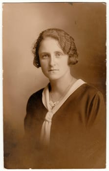 GERMANY - CIRCA 1930s: Vintage photo shows woman - portrait. Retro black and white studio photography with sepia effect.