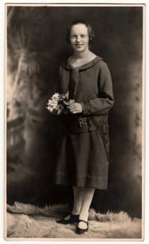 HEJNICE - HAINDORF, THE CZECHOSLOVAK REPUBLIC - CIRCA 1920s: Vintage photo shows woman poses in a photography studio. Retro black and white studio photography.