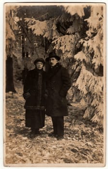 THE CZECHOSLOVAK REPUBLIC CIRCA 1930s: Vintage photo shows a couple in a winter time. Retro black and white photography.