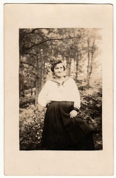 GERMANY - CIRCA 1930s: Vintage photo shows woman outside. Retro black and white studio photography with sepia effect.