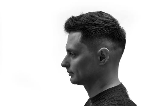 side view of man with stylish hair and beard on white background