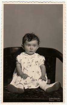 THE CZECHOSLOVAK REPUBLIC - CIRCA 1930s: Vintage photo shows a small baby - girl. Retro black and white studio photography.