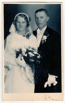 ZLIN, THE CZECHOSLOVAK REPUBLIC - CIRCA 1930s: Vintage photo shows newlyweds. Retro black and white studio photography. Circa 1930s.