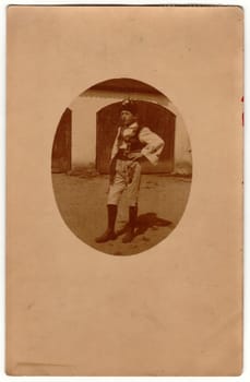 PRAHA - PRAGUE, AUSTRIA-HUNGARY - SEPTEMBER 29, 1918: Vintage photo shows a young boy wears traditional Moravian folk costume. Retro black and white photography. Photo was taken in Austro-Hungarian Empire or also Austro-Hungarian Monarchy. Circa 1920s.