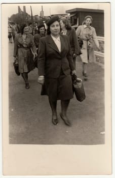 THE CZECHOSLOVAK REPUBLIC - MAY 1946: Vintage photo shows women go from the work. Retro black and white photography. Circa 1940s.