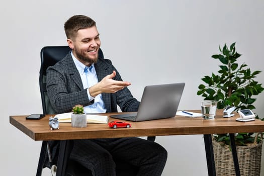 young friendly Freelancer man talking on video call to client, sitting on chair at desk, using laptop pc computer