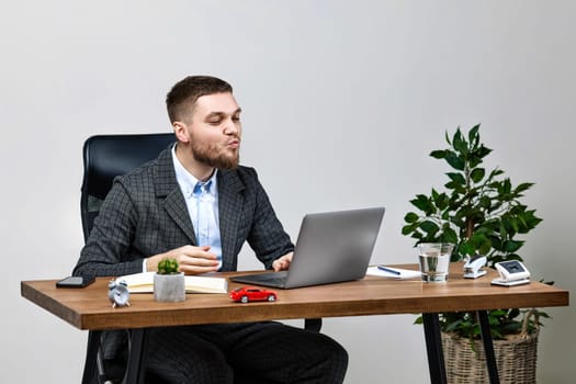 handsome man sitting at desk work on laptop pc computer, talking on video call to his girlfriend