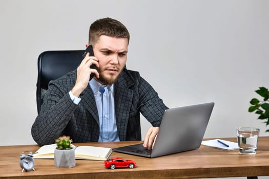 freelancer man working with laptop and using his phone