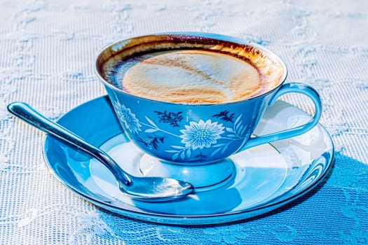 Milk tea or latte coffee with milk in blue vintage cup