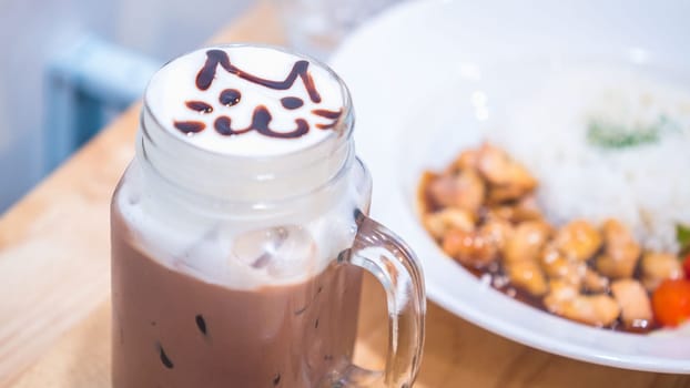 cute cat on top milk foam latte art coffee cup