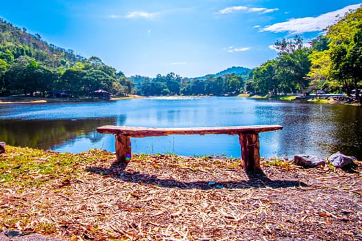 empty park benchon Lake Nipissing during a beautifully colourful spring