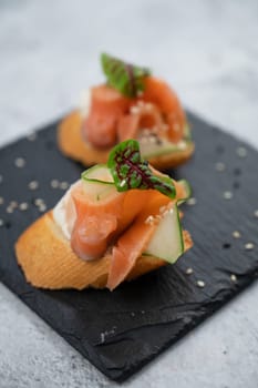 Sandwich with bread salmon slices and soft cheese