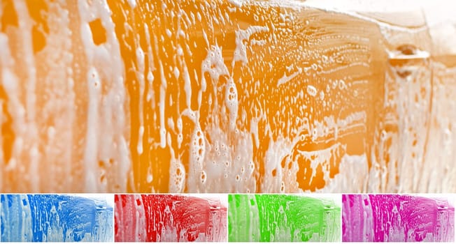 Side of yellow car washed, shampoo and foam on yellow surface. Color can be easily changed with hue shift in photo editor. Abstract car wash background.