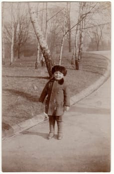 THE CZECHOSLOVAK REPUBLIC - CIRCA 1950s: Vintage photo shows a small cute boy wears fur cap - Cossack hat. Retro black and white photography. Circa 1950s.