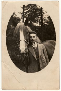 THE CZECHOSLOVAK REPUBLIC - JULY 1919: Vintage photo shows a gentleman with horse. Retro black and white photography. Circa 1920s.