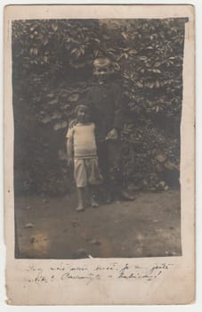 AUSTRIA-HUNGARY - CIRCA 1915: Vintage photo shows two boys - siblings outdoors. Retro black and white photography. Circa 1920s.